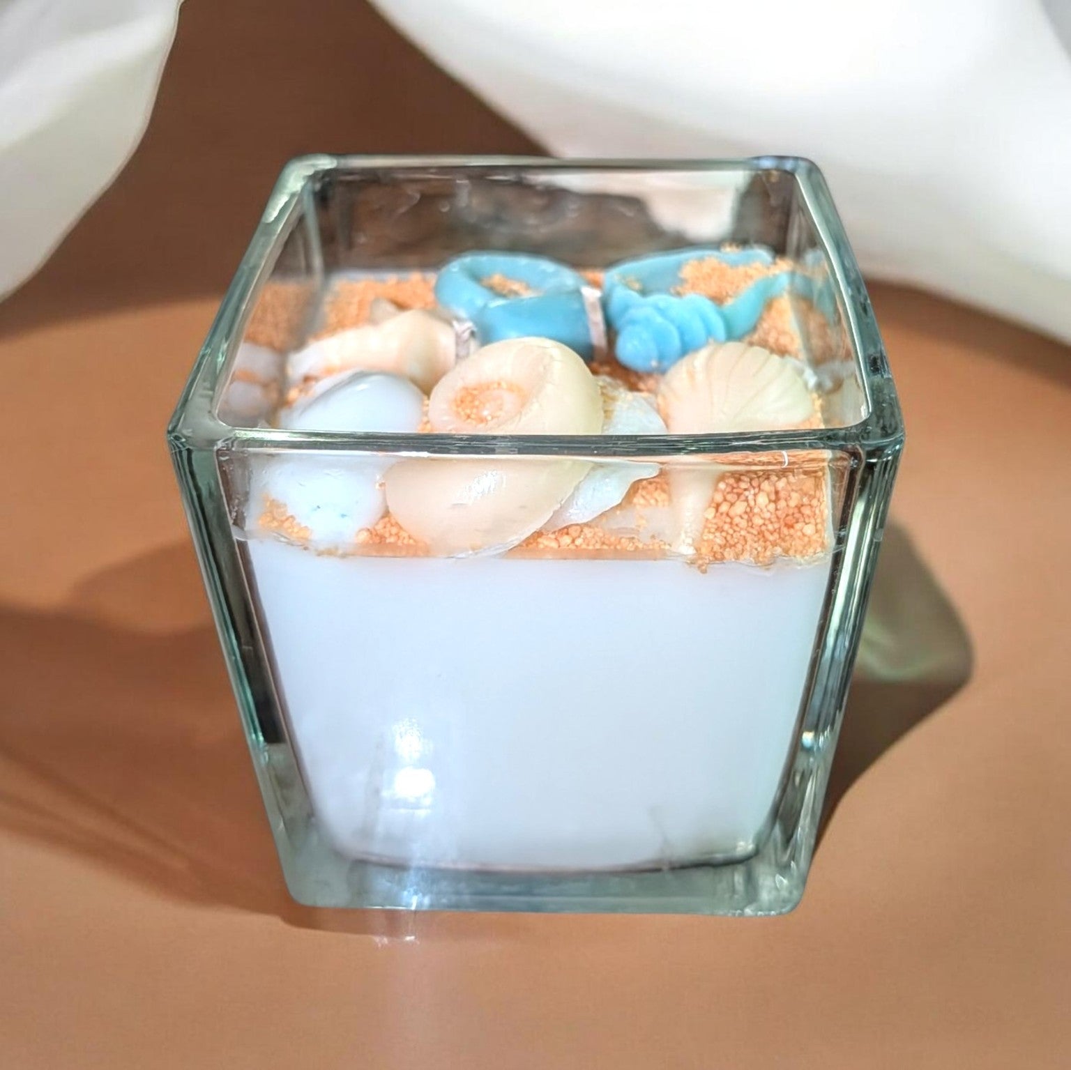 Ocean Waters square glass candle with moving wax sand and seashell embeds